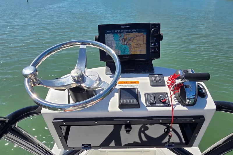 Slide: The Image of Steering console of 2016 Ranger 2510 Bay Ranger with navigation display on calm water. - 39