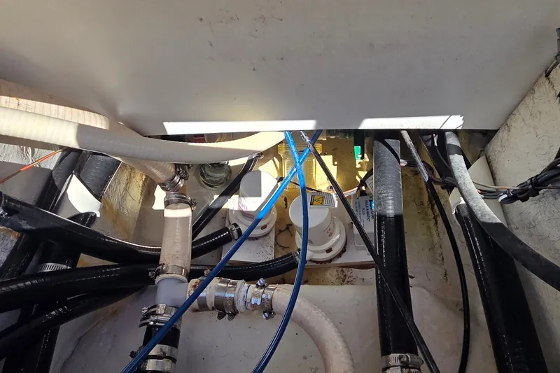 Slide: The Image of 2016 Ranger 2510 Bay Ranger boat interior with visible hoses and wiring. - 16