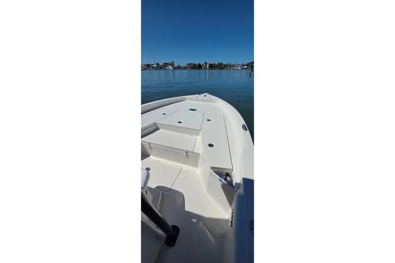 Slide: The Image of 2016 Ranger 2510 Bay Ranger boat on calm water, clear sky background. - 6
