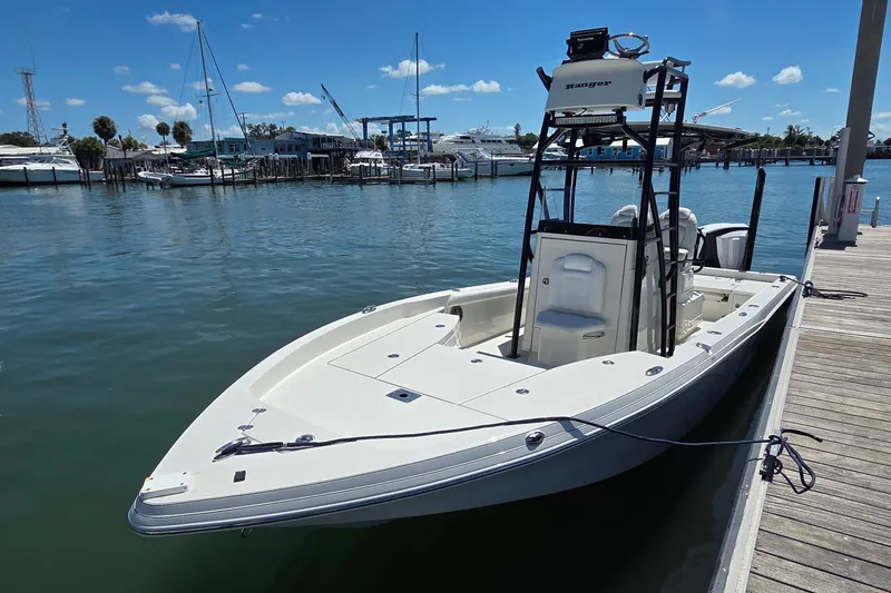Slide: The Image of 2016 Ranger 2510 Bay Ranger boat docked at marina under clear blue sky. - 1