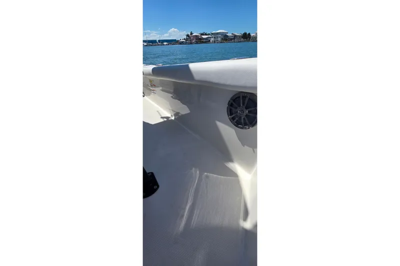 Slide: The Image of 2016 Ranger 2510 Bay Ranger boat interior with speaker, on calm water. - 35