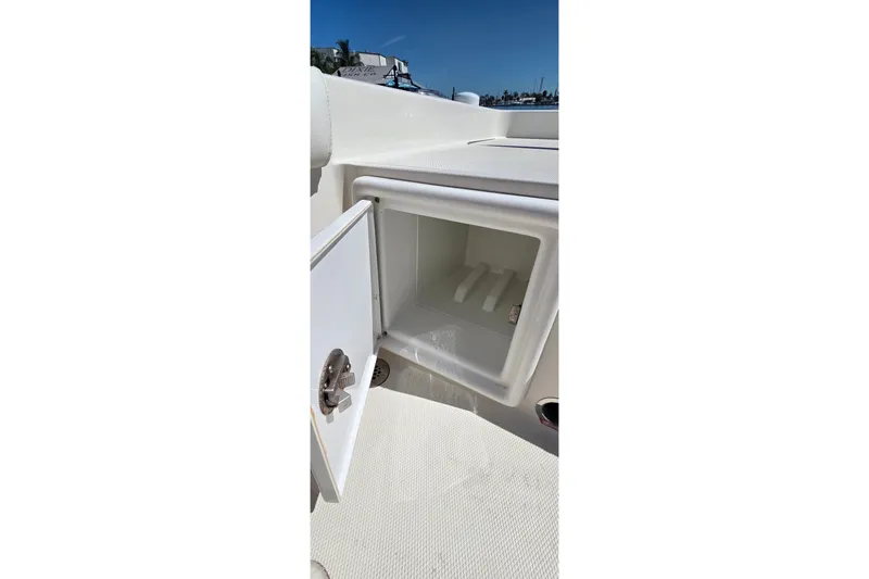 Slide: The Image of Open storage compartment on 2016 Ranger 2510 Bay Ranger boat under clear blue sky. - 9