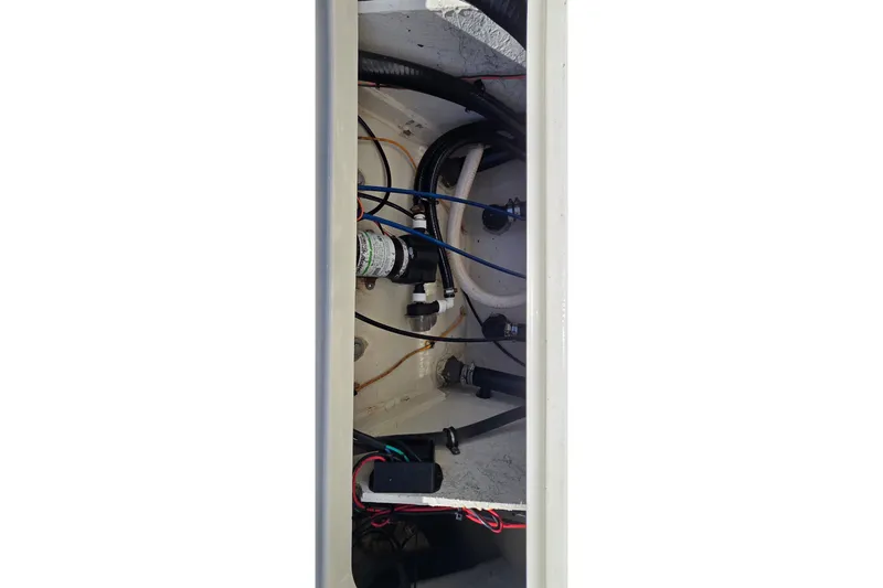 Slide: The Image of Interior view of 2016 Ranger 2510 Bay Ranger boat's wiring and plumbing system. - 15