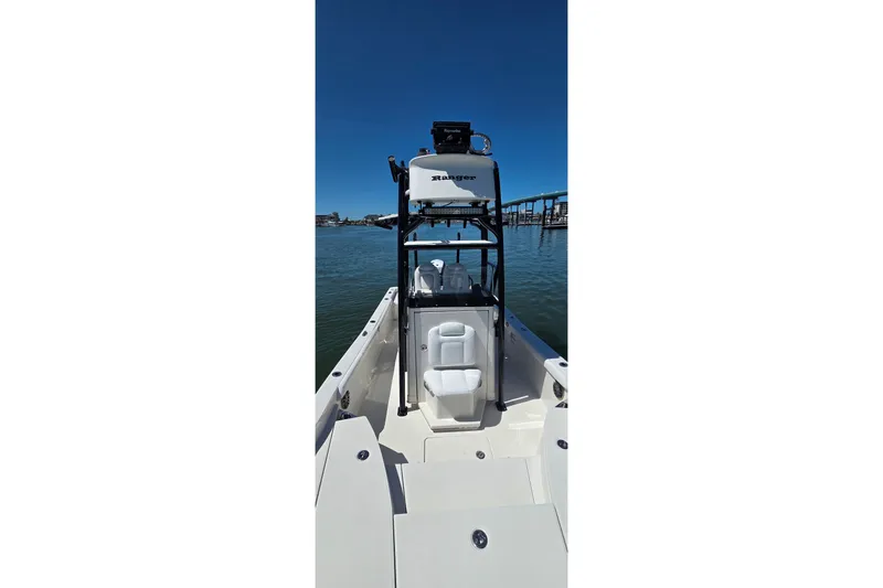 Slide: The Image of 2016 Ranger 2510 Bay Ranger boat on calm water, featuring sleek design and spacious deck. - 46