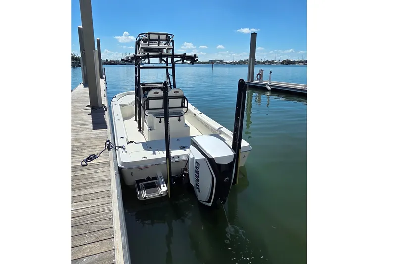 Slide: The Image of 2016 Ranger 2510 Bay Ranger boat docked on calm water under clear sky. - 5