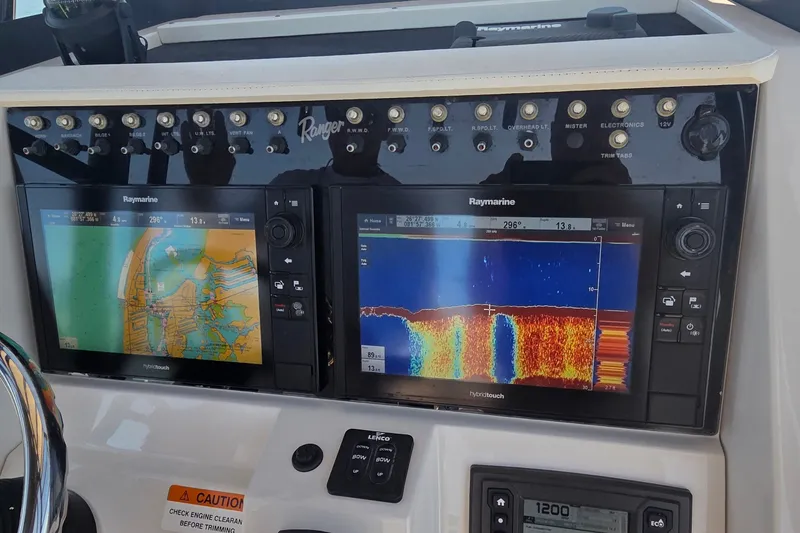 Slide: The Image of Control panel of a 2016 Ranger 2510 Bay Ranger with Raymarine navigation displays. - 23