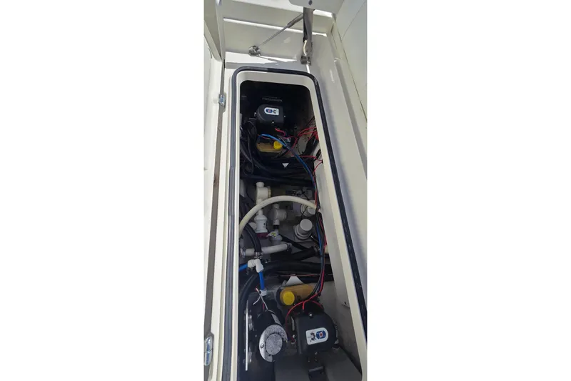Slide: The Image of 2016 Ranger 2510 Bay Ranger boat compartment with wiring and components visible. - 18