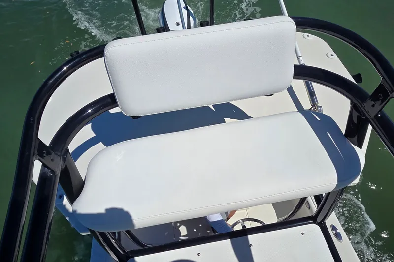 Slide: The Image of 2016 Ranger 2510 Bay Ranger boat seat with white upholstery on water. - 44