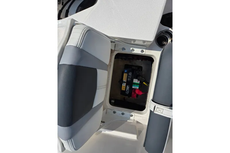 Slide: The Image of 2025 Robalo R180 Center Console boat battery compartment with open seat access. - 26