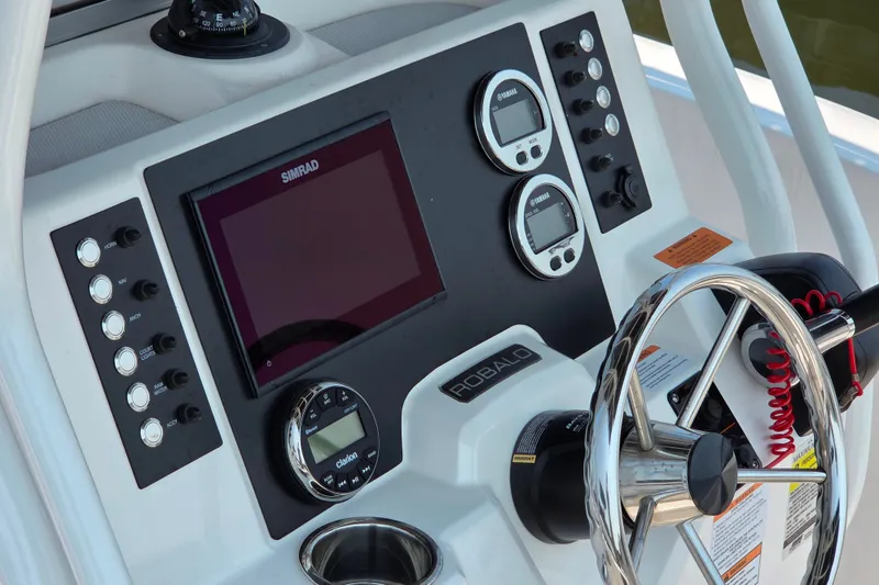 Slide: The Image of 2025 Robalo R180 Center Console dashboard with Simrad display and Yamaha gauges. - 29
