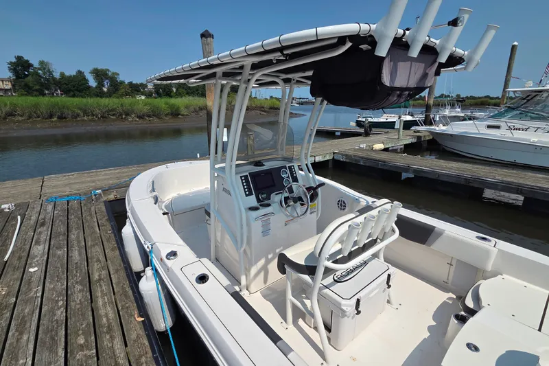 Slide: The Image of 2025 Robalo R180 Center Console boat docked at marina, featuring sleek design and modern controls. - 25