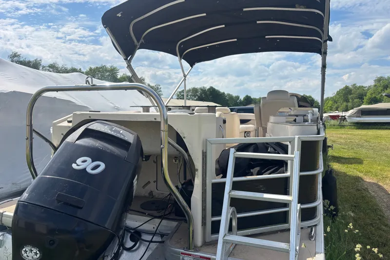 Slide: The Image of 2011 AquaPatio AP250W6 pontoon boat with canopy and 90 HP outboard motor. - 1