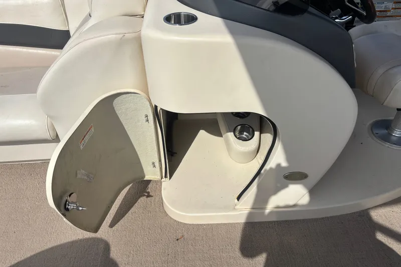 Slide: The Image of Open storage compartment on 2011 AquaPatio AP250W6 boat console. - 8