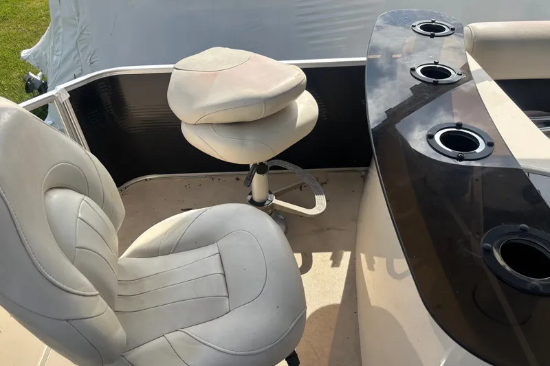 Slide: The Image of AquaPatio AP250W6 2011 boat interior with seating and cup holders. - 12