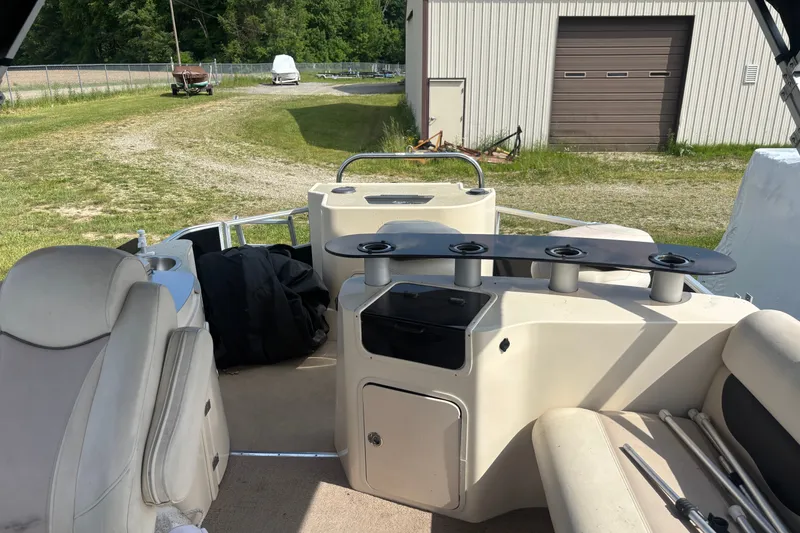 Slide: The Image of Interior of 2011 AquaPatio AP250W6 boat with seating and storage compartments. - 9