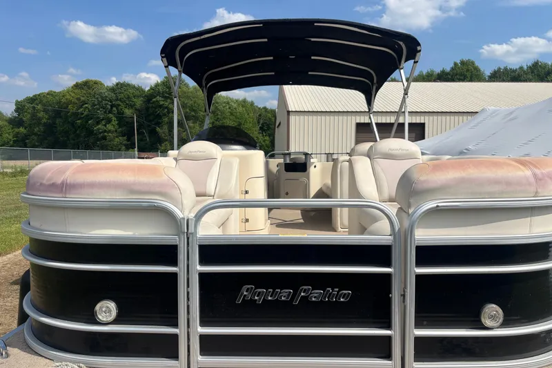 Slide: The Image of 2011 AquaPatio AP250W6 pontoon boat with canopy, parked outdoors under blue sky. - 3
