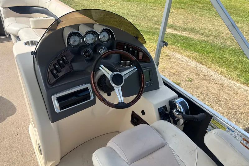 Slide: The Image of Steering console of 2011 AquaPatio AP250W6 boat with gauges and controls. - 6