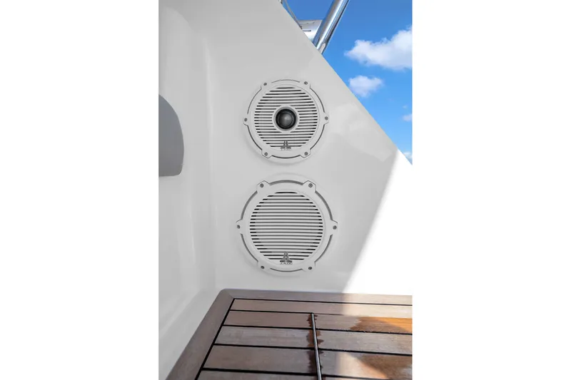 Slide: The Image of Speakers on a 2012 Viking 76 Convertible yacht with wooden deck and blue sky. - 55
