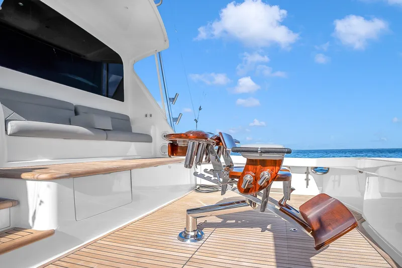Slide: The Image of Luxury Viking 76 Convertible yacht deck with seating, 2012 model, under clear blue sky. - 54