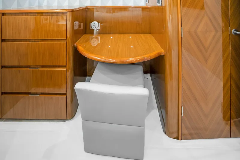 Slide: The Image of Luxurious wooden interior of 2012 Viking 76 Convertible yacht with desk and chair. - 86