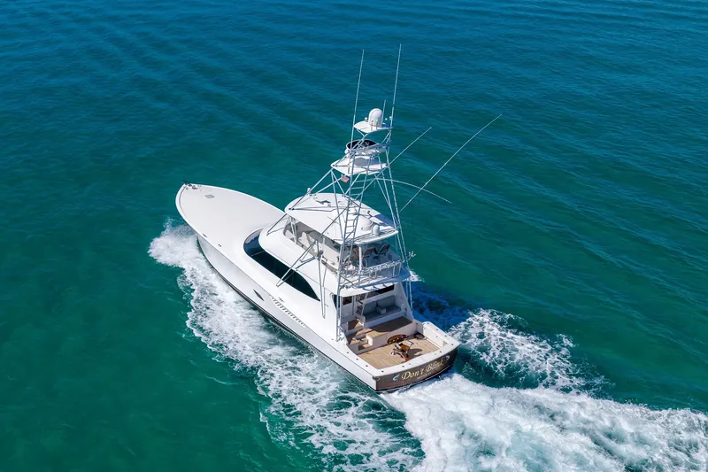 Slide: The Image of 2012 Viking 76 Convertible yacht cruising on clear blue ocean waters. - 17