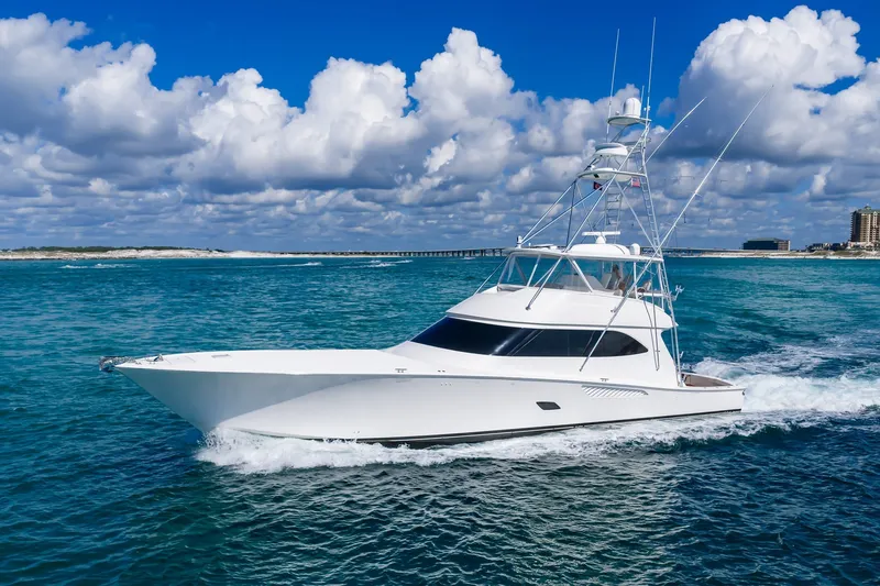Slide: The Image of 2012 Viking 76 Convertible yacht cruising on blue ocean under cloudy sky. - 12