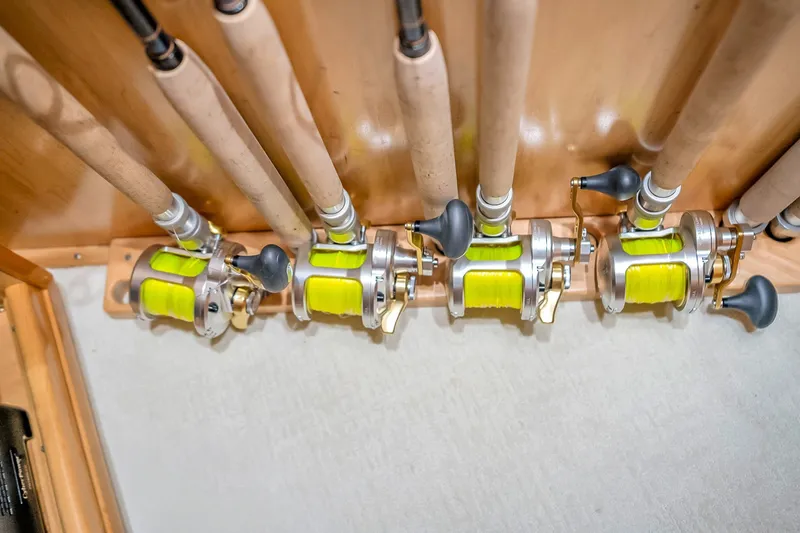 Slide: The Image of Fishing rods with reels and yellow line on a Viking 76 Convertible yacht, 2012 model. - 119