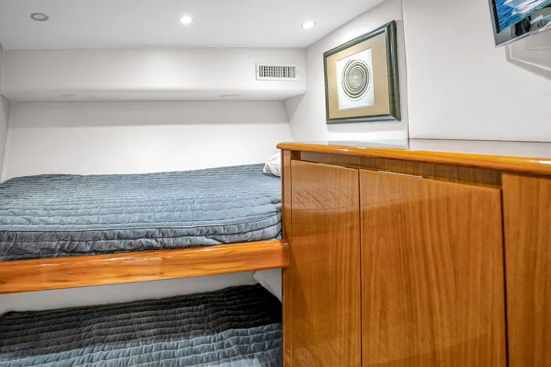 Slide: The Image of Interior of 2012 Viking 76 Convertible yacht with cozy bunk beds and elegant wood cabinetry. - 114