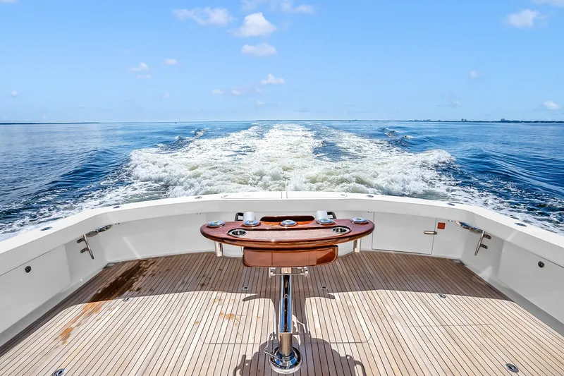 Slide: The Image of Aft deck view of 2012 Viking 76 Convertible yacht cruising on open water. - 49