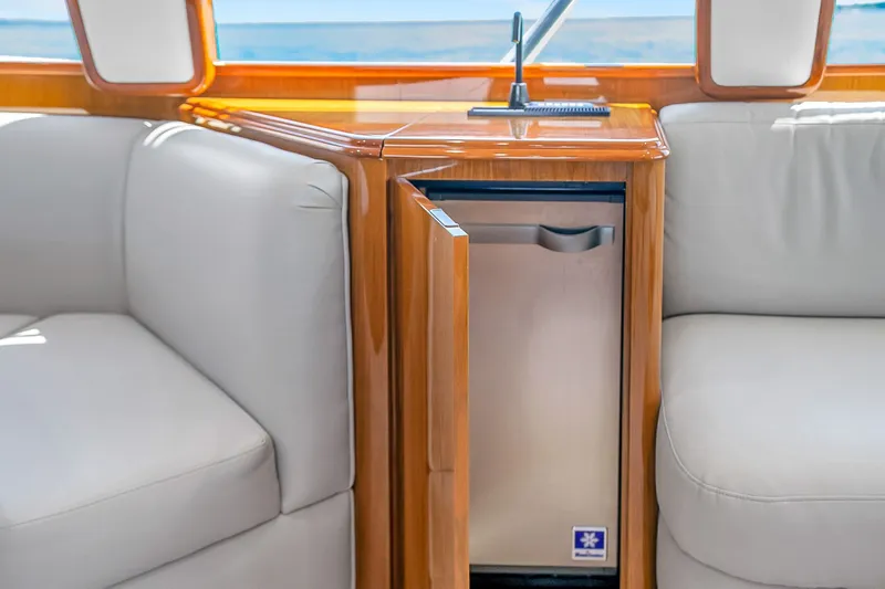 Slide: The Image of Luxurious interior of 2012 Viking 76 Convertible yacht with mini fridge and plush seating. - 120