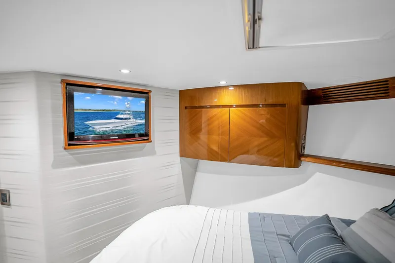 Slide: The Image of Luxurious cabin interior of 2012 Viking 76 Convertible yacht with TV and wooden cabinetry. - 108