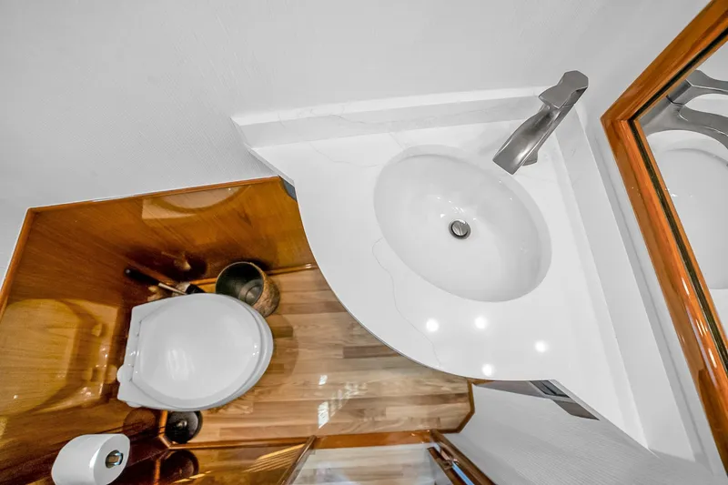 Slide: The Image of Luxurious bathroom in 2012 Viking 76 Convertible yacht with modern sink and toilet. - 59