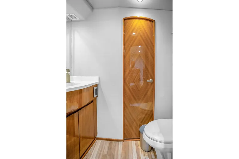 Slide: The Image of Luxurious bathroom interior of 2012 Viking 76 Convertible yacht with wooden accents. - 105