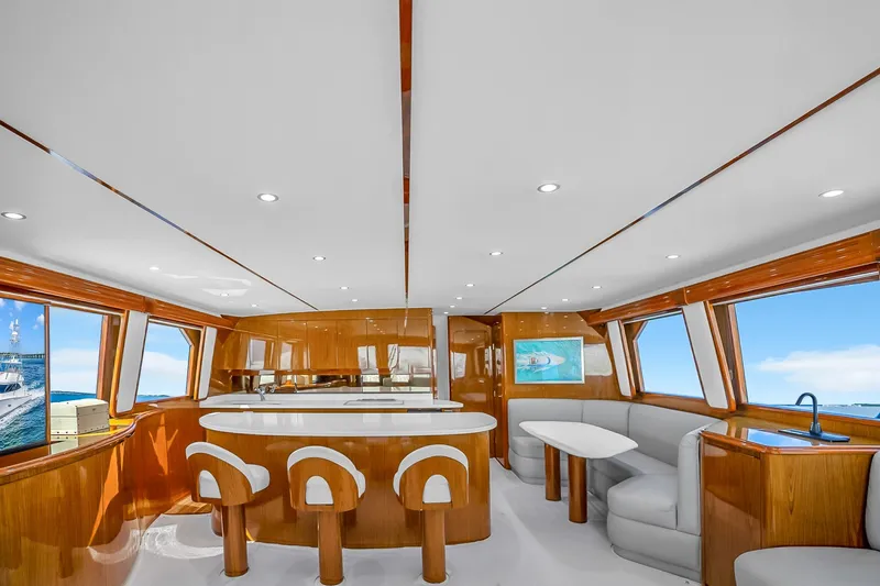 Slide: The Image of Luxurious interior of 2012 Viking 76 Convertible yacht with modern seating and panoramic windows. - 58