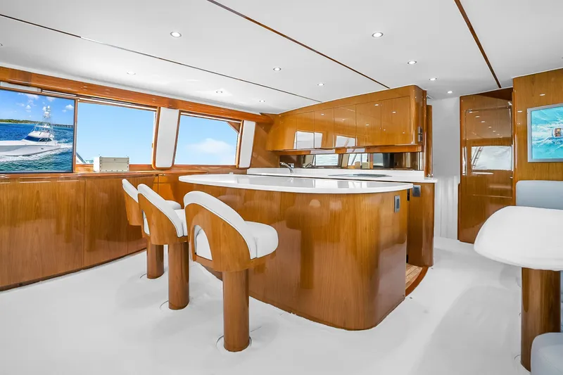 Slide: The Image of Luxurious interior of a 2012 Viking 76 Convertible yacht with elegant wood finishes. - 63
