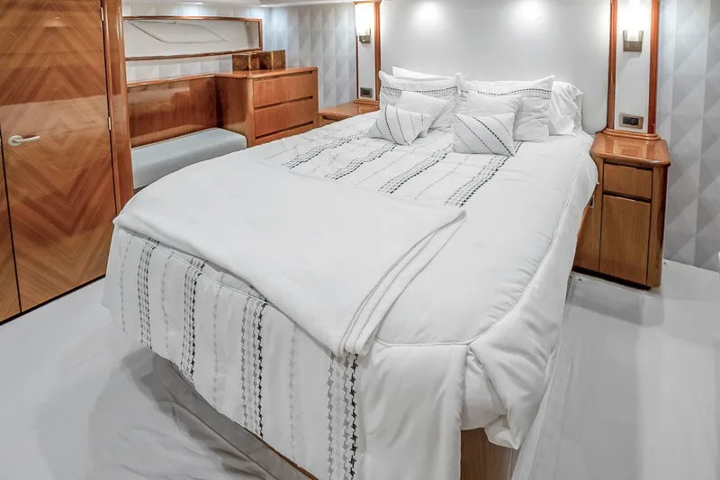 Slide: The Image of Luxurious bedroom interior of 2012 Viking 76 Convertible yacht with elegant wood finishes. - 93