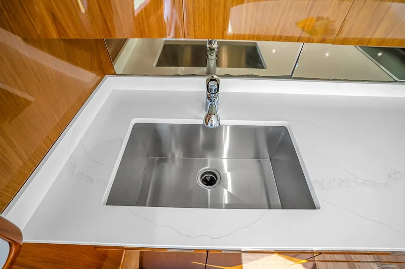 Slide: The Image of Stainless steel sink in 2012 Viking 76 Convertible yacht kitchen. - 71