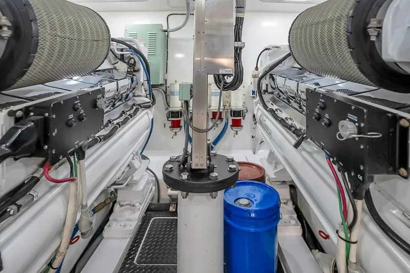 Slide: The Image of Engine room of a 2012 Viking 76 Convertible yacht, showcasing machinery and components. - 129