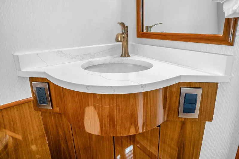 Slide: The Image of Luxurious bathroom vanity in 2012 Viking 76 Convertible yacht, featuring elegant wood and marble design. - 60