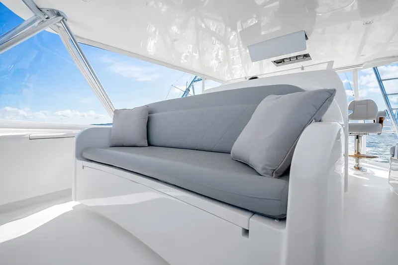 Slide: The Image of Luxurious seating area on a 2012 Viking 76 Convertible yacht, featuring plush cushions and ocean views. - 41