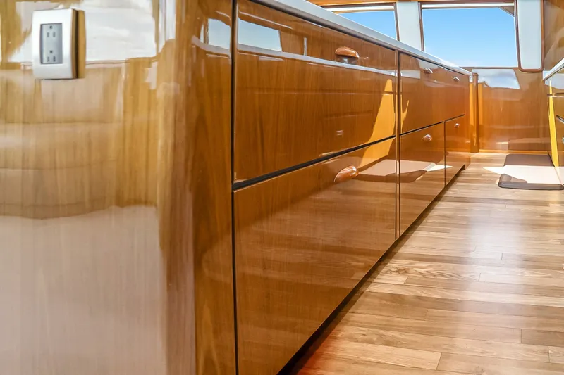 Slide: The Image of Luxurious wooden interior of a 2012 Viking 76 Convertible yacht, featuring sleek cabinetry. - 69