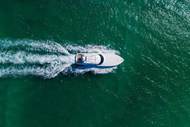 Slide: The Image of Aerial view of 2012 Viking 76 Convertible yacht cruising on turquoise water. - 11