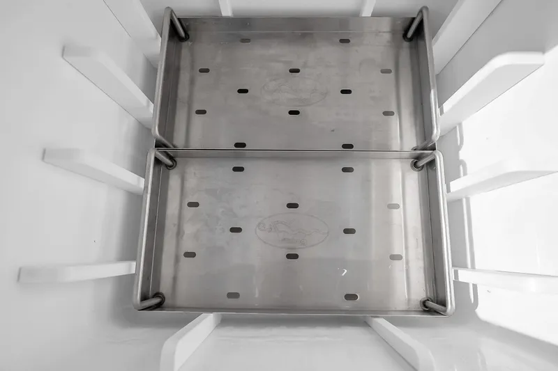 Slide: The Image of Interior of a 2012 Viking 76 Convertible, featuring stainless steel storage compartments. - 139
