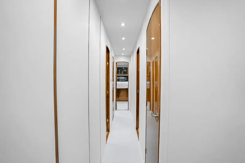Slide: The Image of Interior hallway of 2012 Viking 76 Convertible yacht with sleek design and wooden accents. - 84