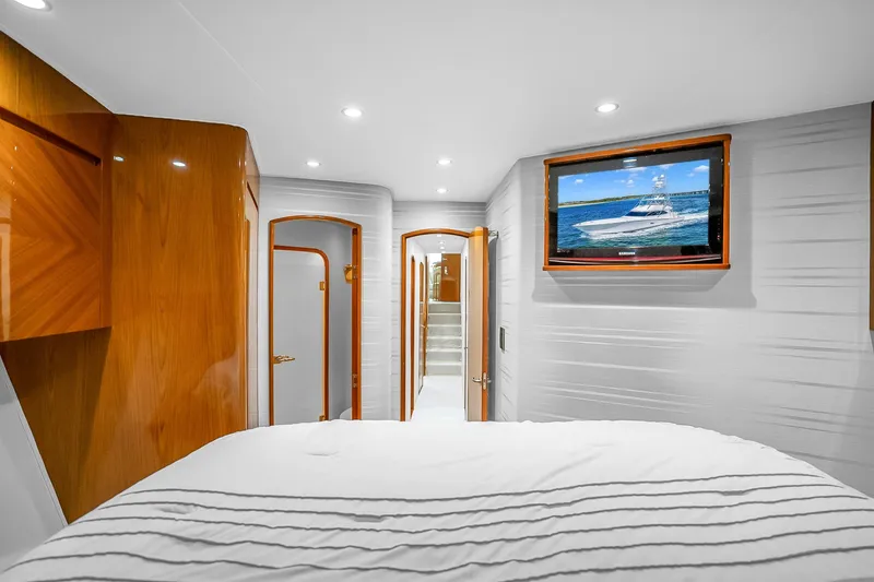 Slide: The Image of Luxurious interior of 2012 Viking 76 Convertible yacht with wood accents and wall-mounted TV. - 109