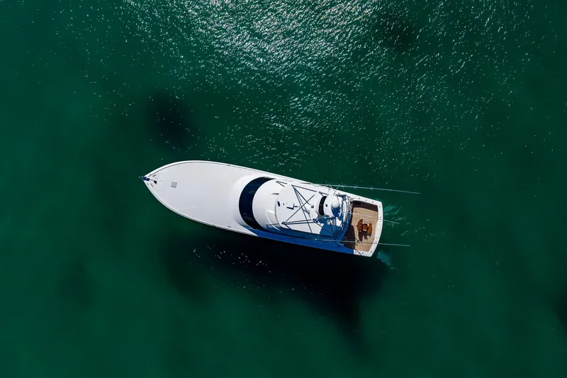Slide: The Image of Aerial view of 2012 Viking 76 Convertible yacht on clear green water. - 18