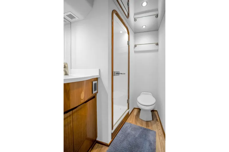 Slide: The Image of Bathroom interior of 2012 Viking 76 Convertible yacht, featuring shower and toilet. - 99