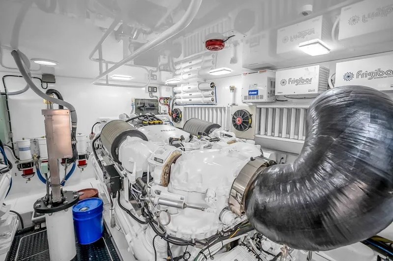 Slide: The Image of Engine room of a 2012 Viking 76 Convertible yacht, featuring advanced machinery and equipment. - 124