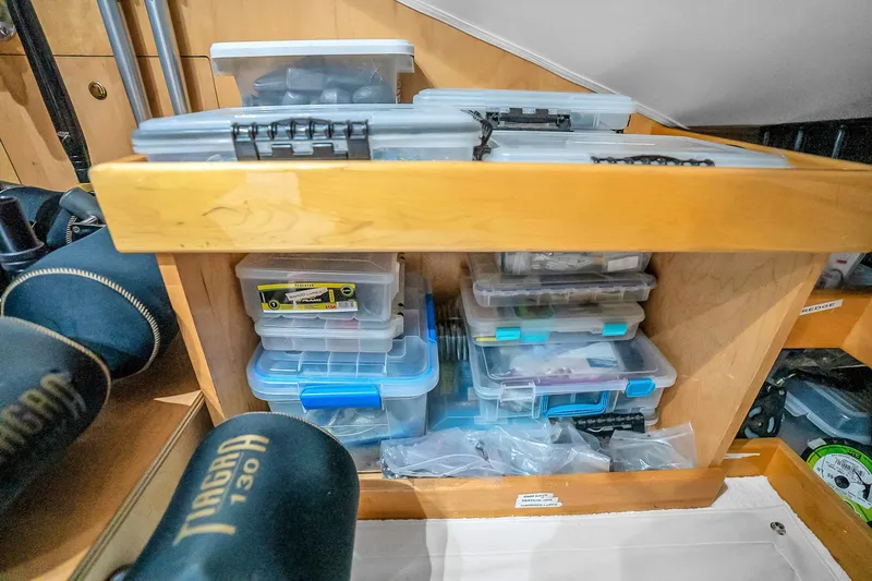 Slide: The Image of Storage area with organized plastic containers on a 2012 Viking 76 Convertible yacht. - 79
