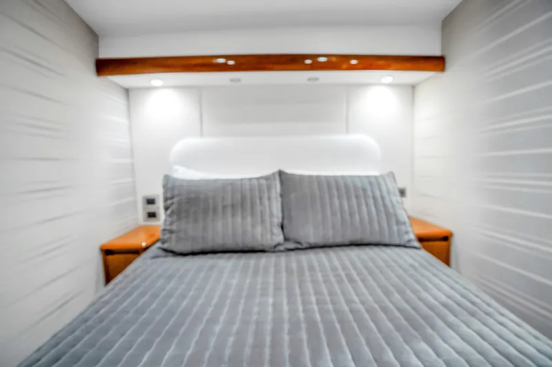 Slide: The Image of Luxurious bedroom interior of 2012 Viking 76 Convertible yacht with modern gray bedding. - 103